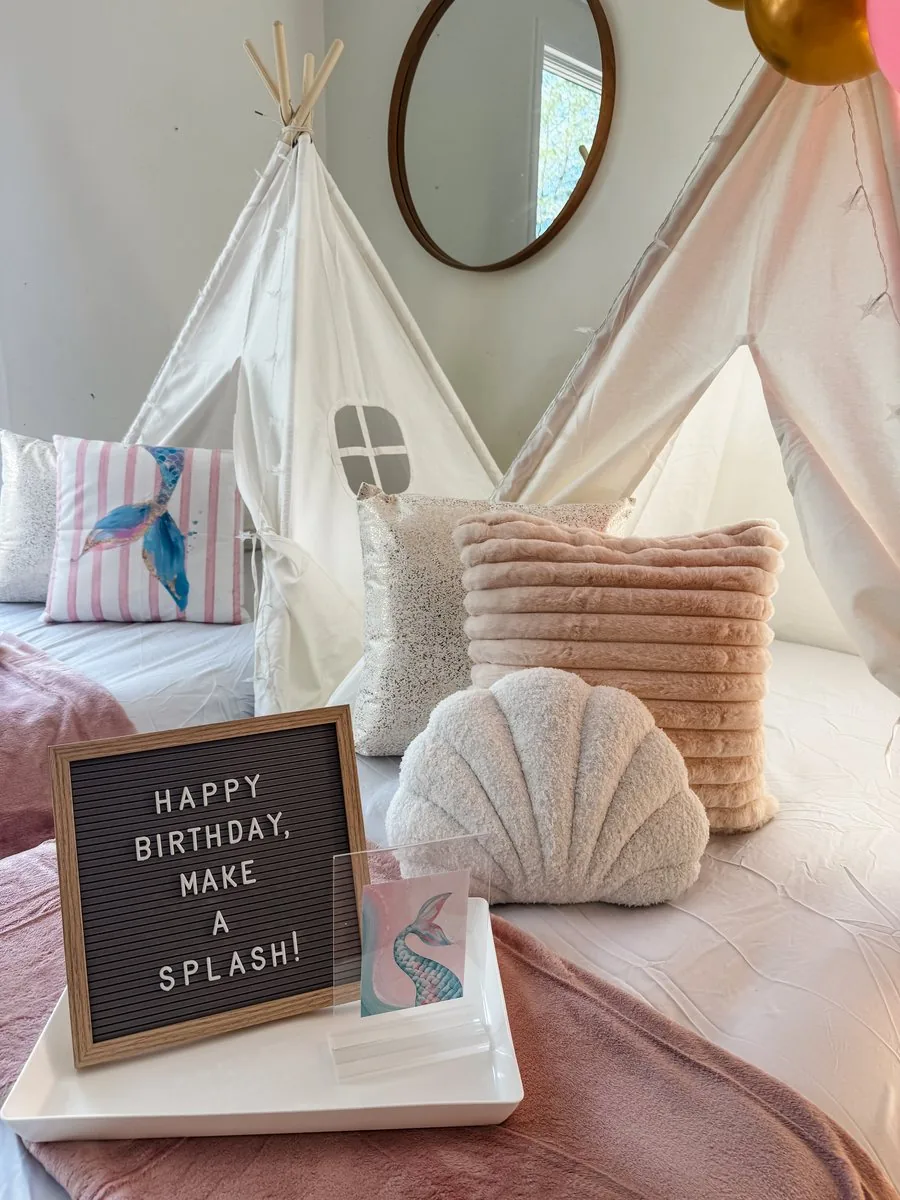 Custom Happy Birthday, Make a Splash letter board party sign styled on a mermaid-themed teepee bed