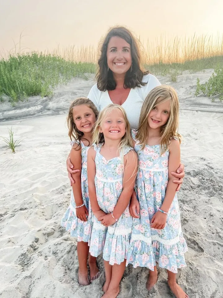Hannah, founder of Hello Teepees, with her three daughters on the beach at sunset
