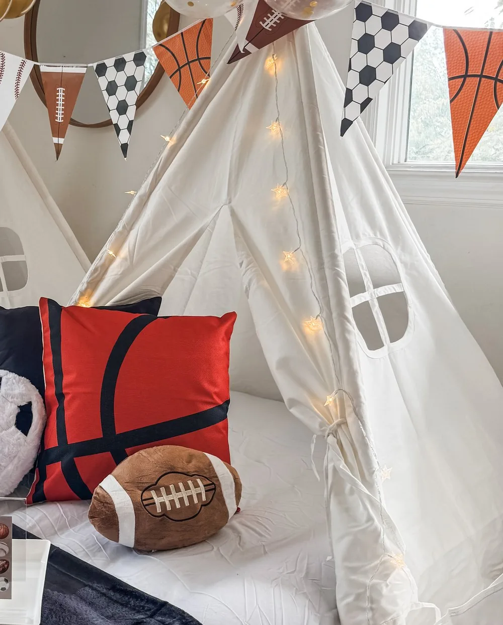 Warm string fairy lights with tiny stars glowing on a white teepee
